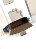 Fendi small crossbody bag open view, blue exterior with brown interior and flap hardware