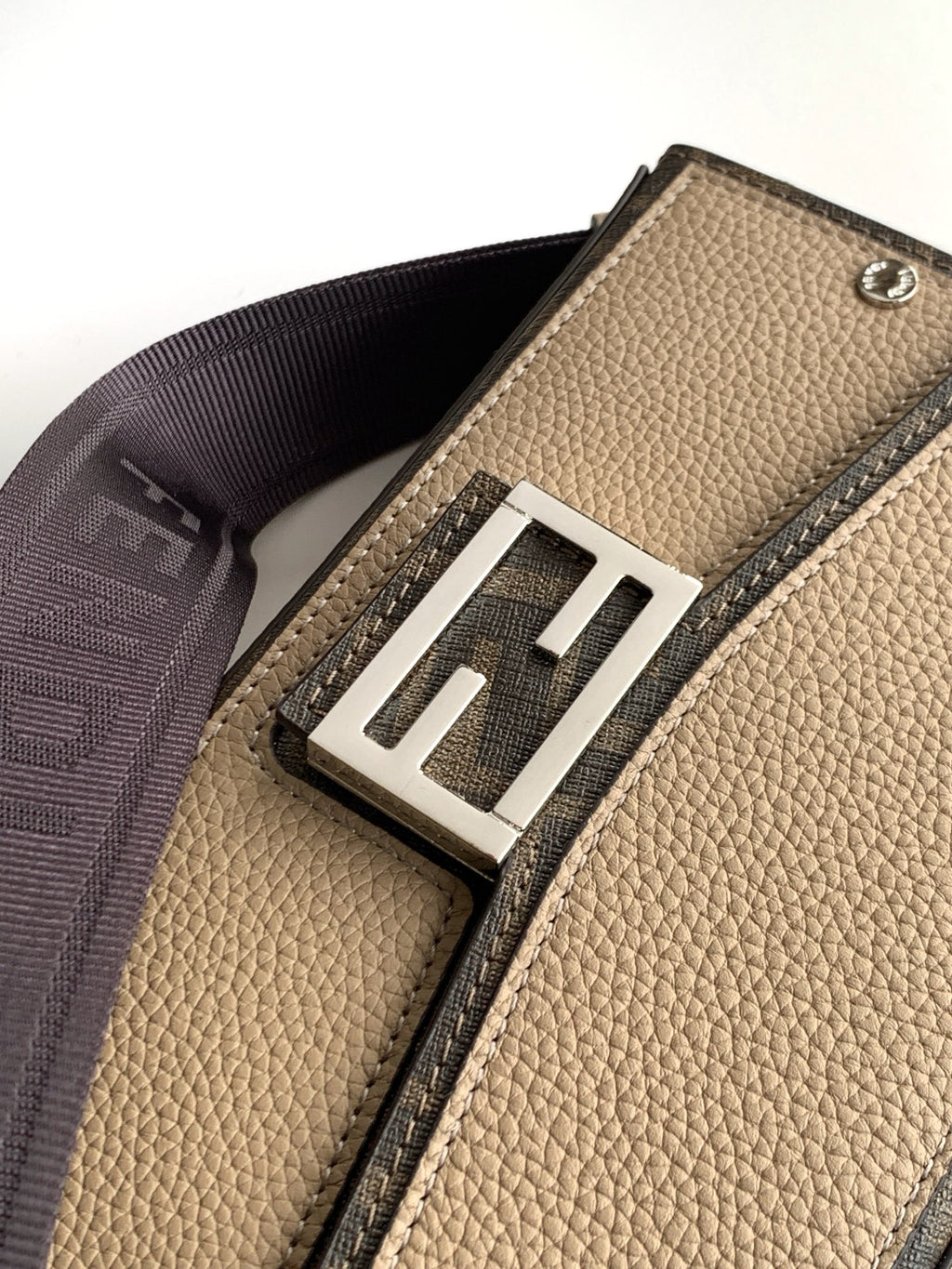 Fendi webbing strap with metal slider on textured beige mini bag