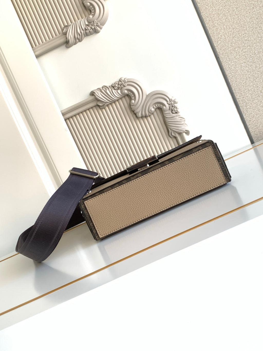 Fendi flap bag in textured beige with navy web shoulder strap and silver hardware