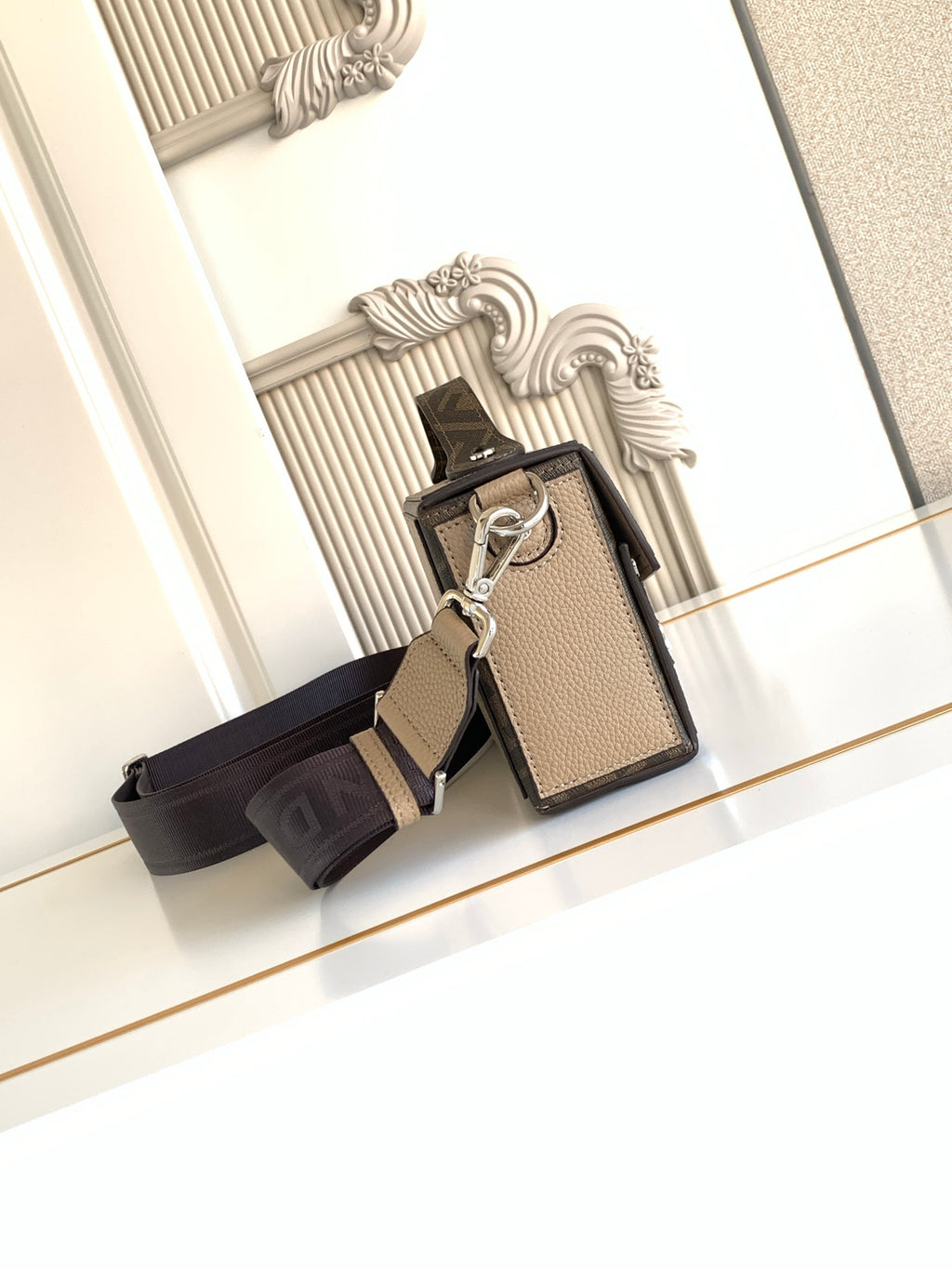 Fendi mini bag with keyring accessory, textured beige front, black crossbody strap