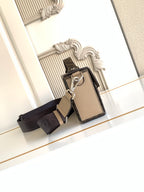 Fendi mini bag with keyring accessory, textured beige front, black crossbody strap