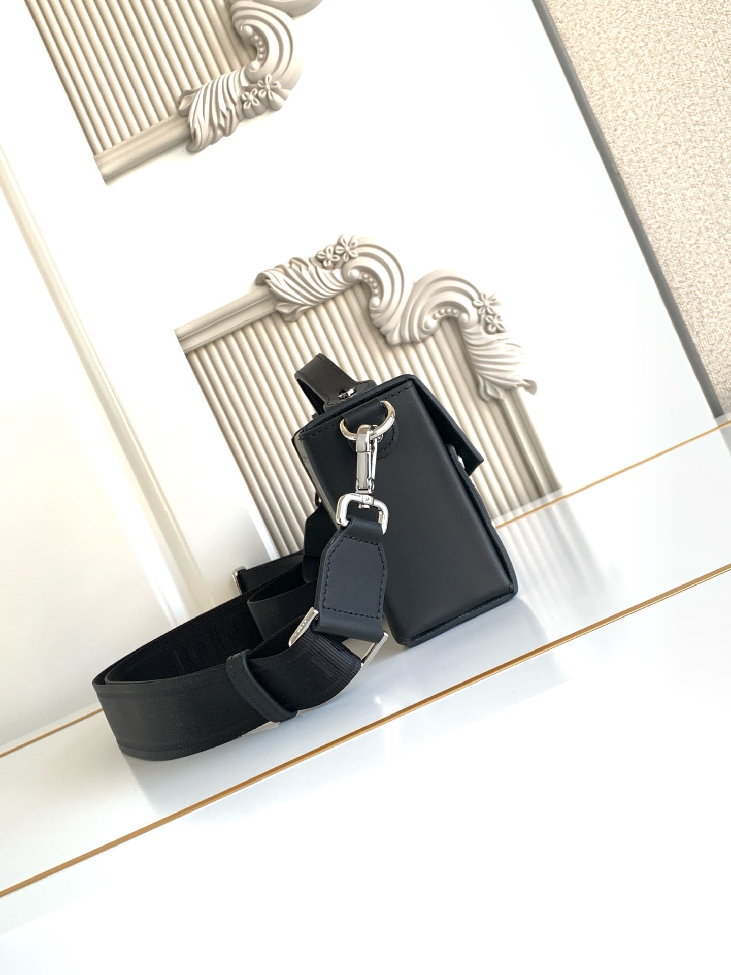 Fendi mini crossbody bag with black exterior and adjustable shoulder strap
