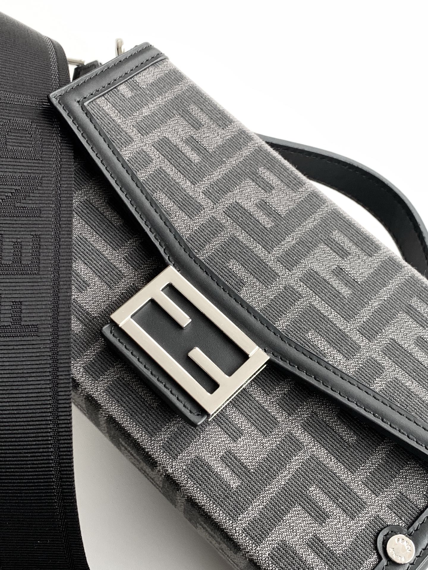 Fendi monogram bag close-up of flap and snap hardware, gray patterned fabric
