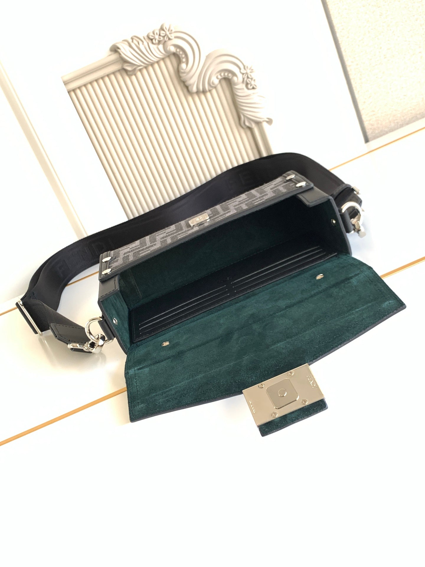 Fendi crossbody bag open view with teal interior and black top flap