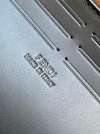Fendi bag leather close-up with embossed text reading FENDI and MADE IN ITALY