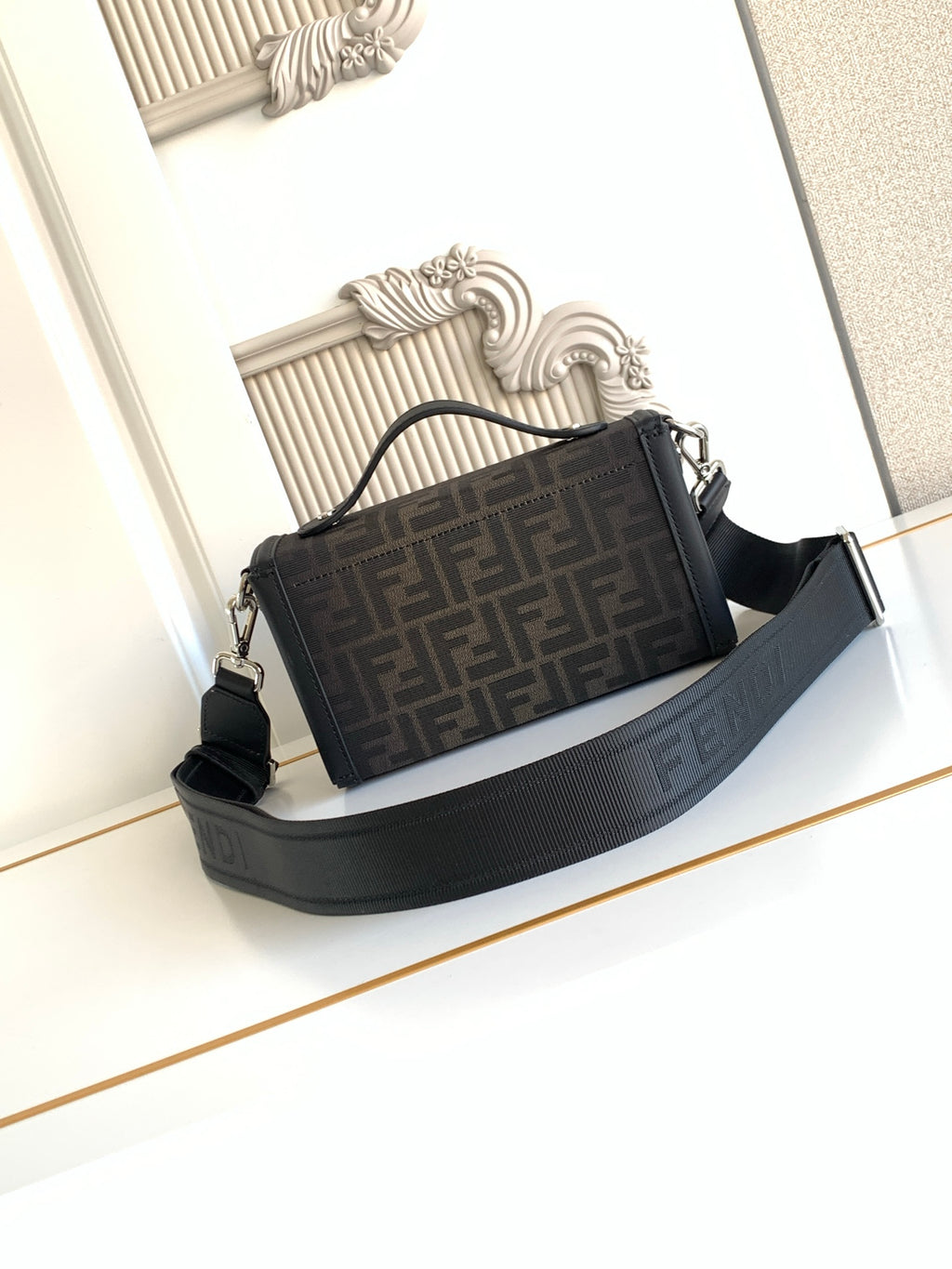 Fendi bag in dark logo canvas with black strap and structured top clasp
