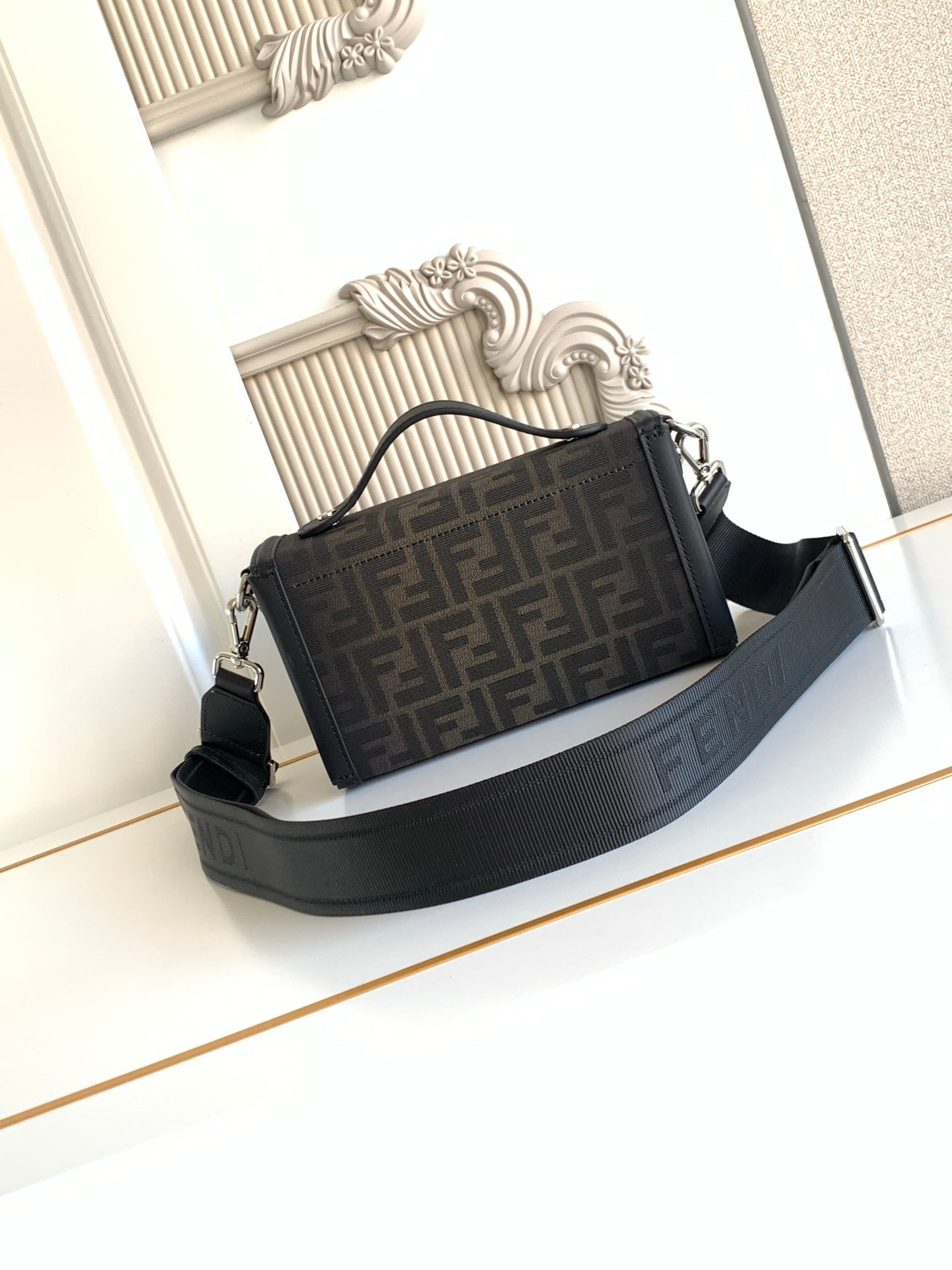 Fendi bag in dark logo canvas with black strap and structured top clasp