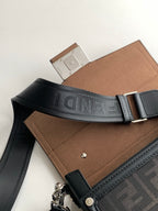 Fendi bag with dark webbed strap showing logo and tan interior flap
