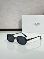 Black and gold sunglasses with dark tinted lenses, front view