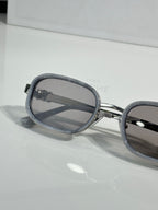 Silver sunglasses with smoky lenses and dark nose bridge detail