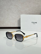 Celine sunglasses with black frames, gold accents, and dark tinted lenses
