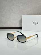 Black and gold sunglasses with dark tinted lenses, angled front