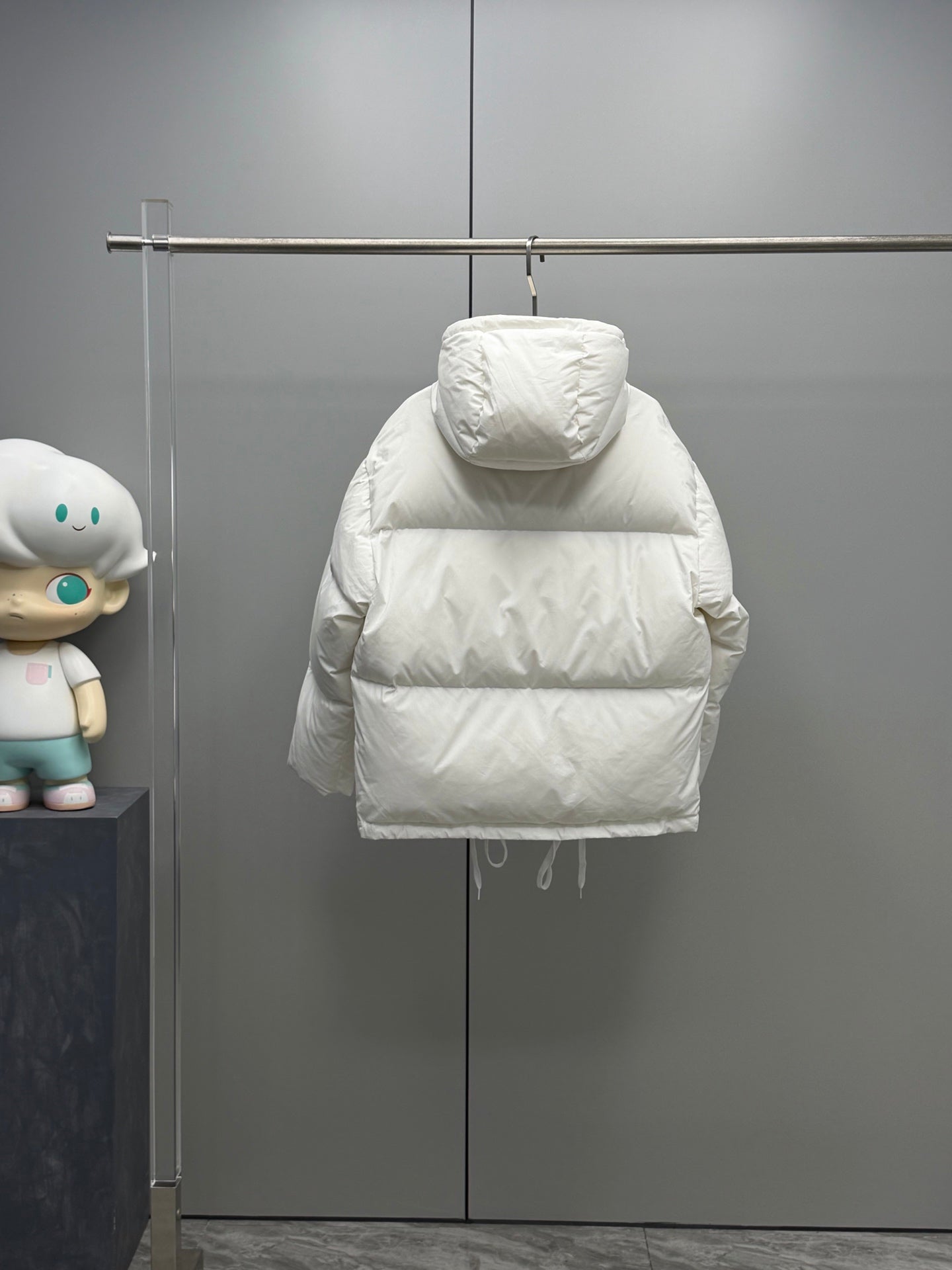 White hooded long puffer jacket front view with snap-button closure