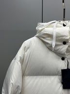 White puffer jacket with attached hood and buttoned shoulder yoke