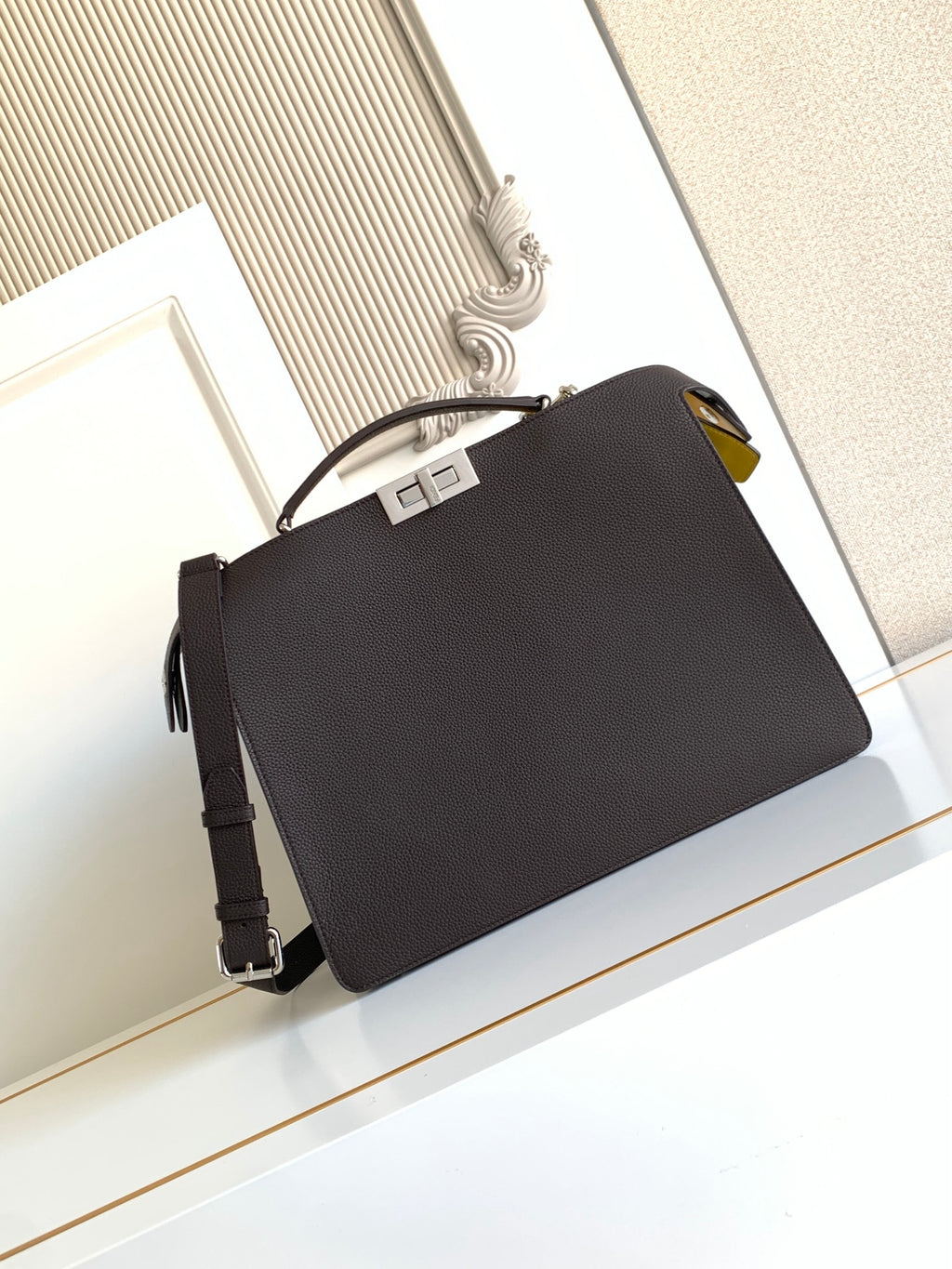 Fendi black crossbody bag with top handle, shoulder strap, and gold-tone hardware
