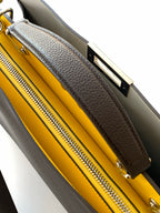 Fendi bag interior with bright yellow lining and zippered compartment