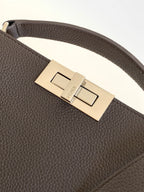 Fendi dark leather belt-style bag with metal buckle and engraved plate