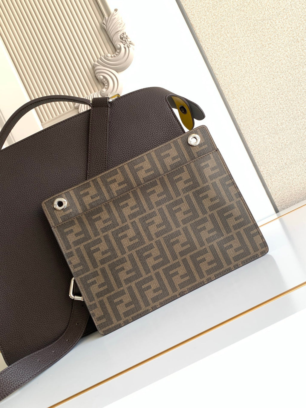 Fendi dark crossbody bag with FF monogram front pocket and gold-tone studs