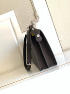 Fendi dark crossbody bag with flap front, front pocket, and adjustable strap