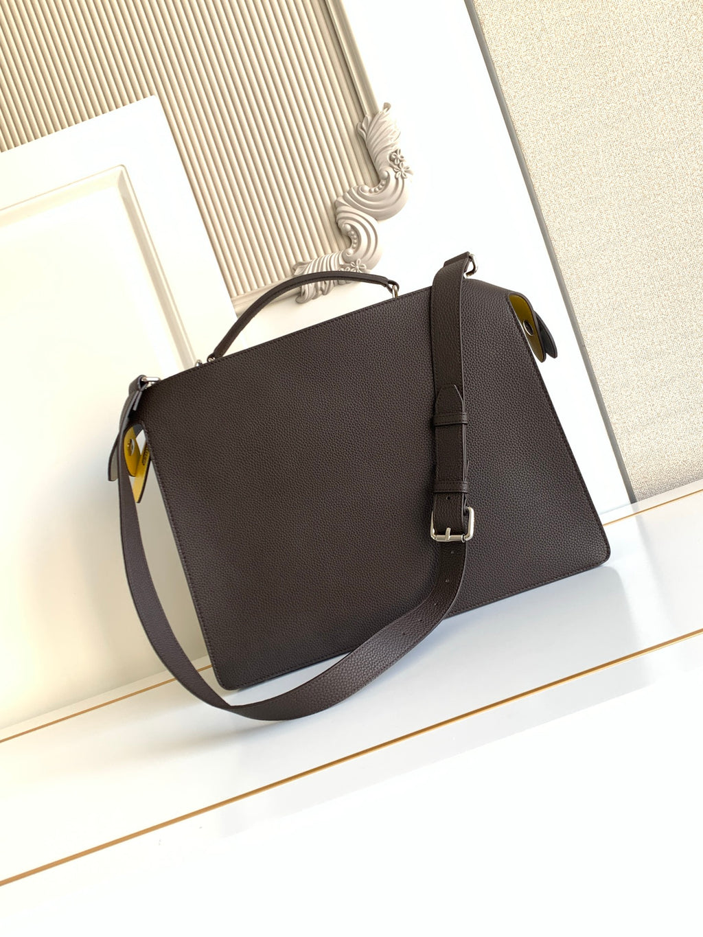 Fendi dark crossbody bag with rounded flap and adjustable shoulder strap