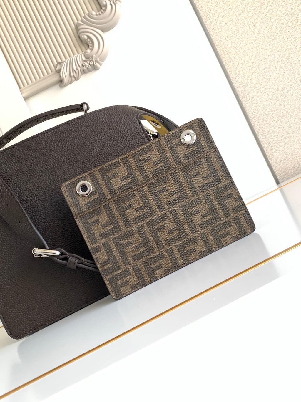 Fendi bag front pocket close-up with FF jacquard panel and silver grommet hardware