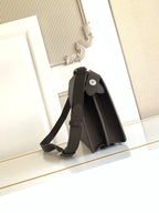 Fendi bag dark textured leather crossbody, adjustable strap, flap with circular emblem