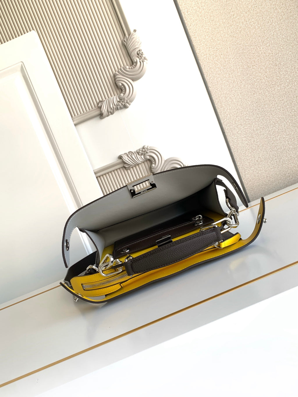 Fendi bag open top with yellow interior lining and visible zipper compartments
