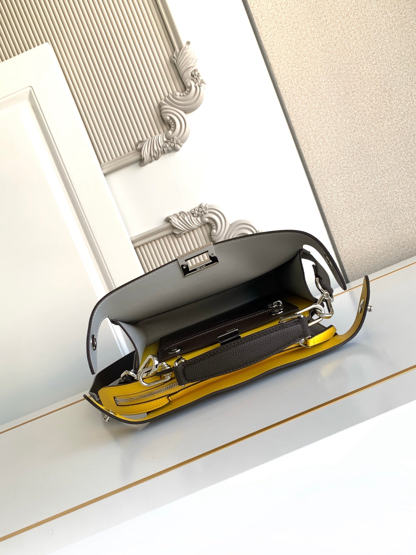Fendi bag open top with yellow interior lining and visible zipper compartments