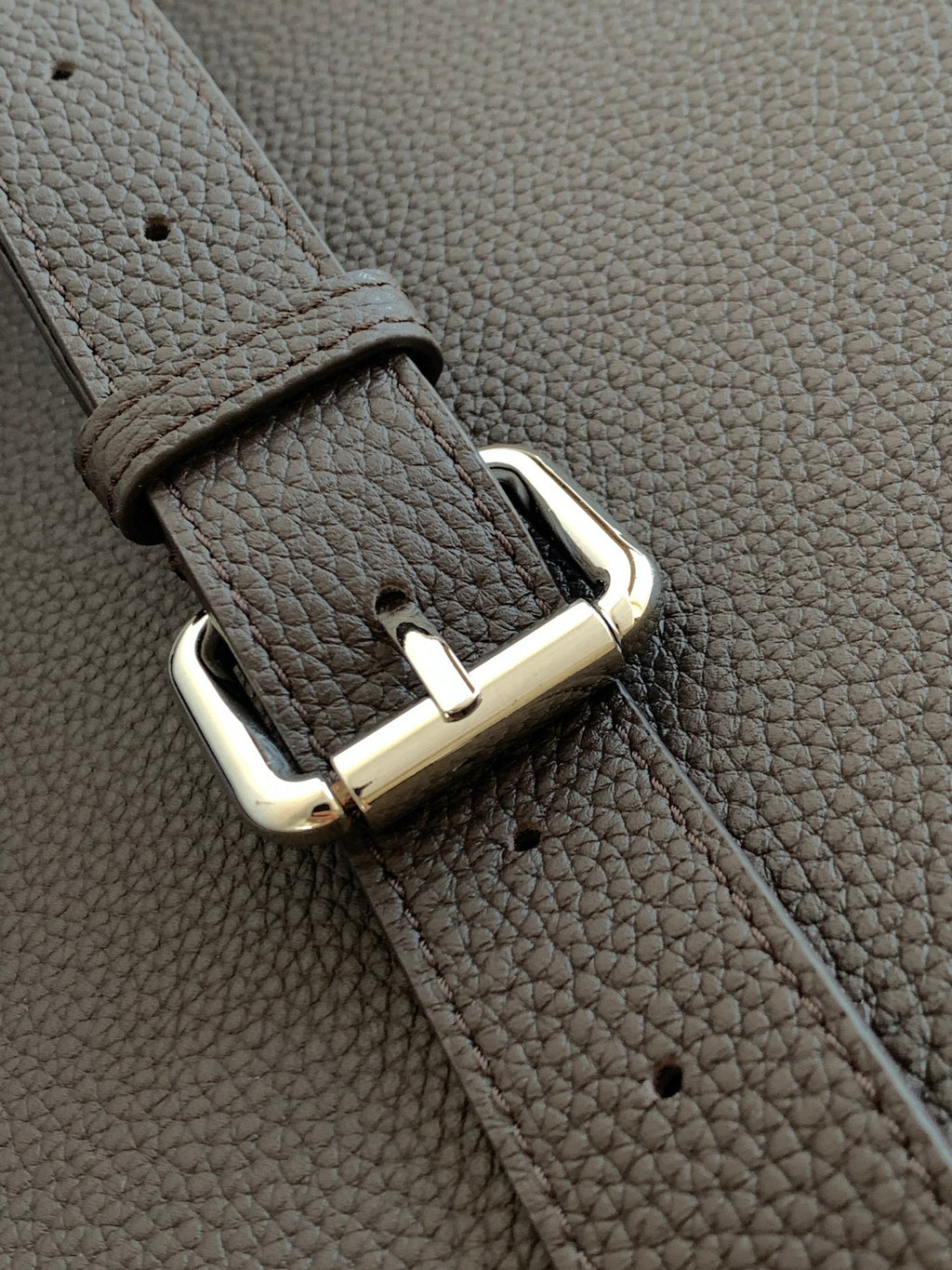 Fendi bag close-up of dark leather strap with silver buckle and riveted hardware