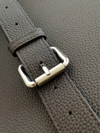 Fendi bag close-up of dark leather strap with silver buckle and riveted hardware