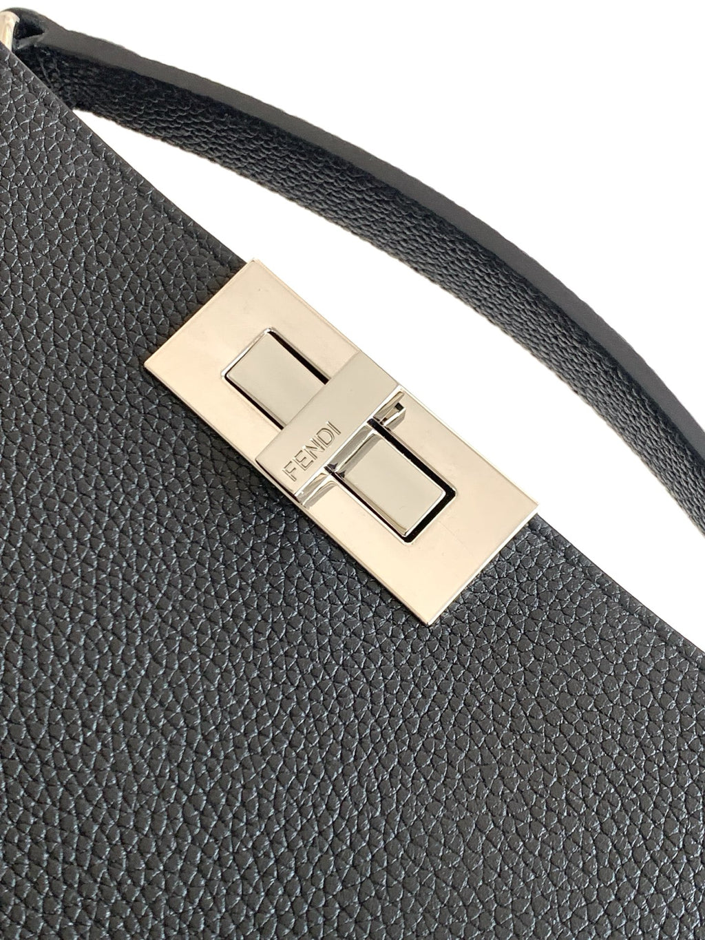 Textured black bag strap with gold-tone buckle and centered Fendi logo plate.