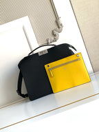 Black crossbody bag with flap and contrasting yellow front pocket with zipper.