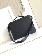 Black crossbody bag with flap closure and wide shoulder strap.