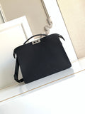 Black crossbody bag with flap, curved handle, and side strap details.