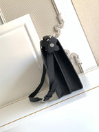 Black crossbody bag with adjustable shoulder strap and metal buckle detail.