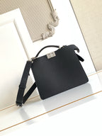 Black leather shoulder bag with gold-tone logo plaque and adjustable strap