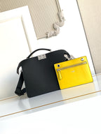 Black leather shoulder bag with bright yellow front pocket and shoulder strap