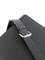Black leather shoulder strap with gold-tone buckle and stitch holes