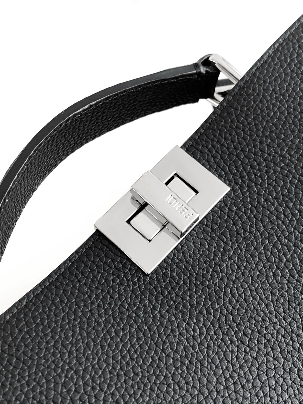 Black leather shoulder strap detail with silver square buckle