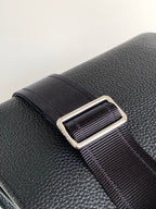 Black textured leather strap with metal adjuster and ribbed webbing