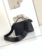 Black pebbled leather handbag with adjustable shoulder strap and buckle