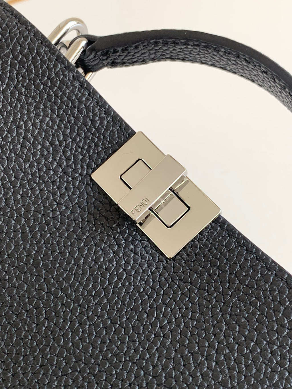 Black pebbled leather strap with square metal buckle clasp