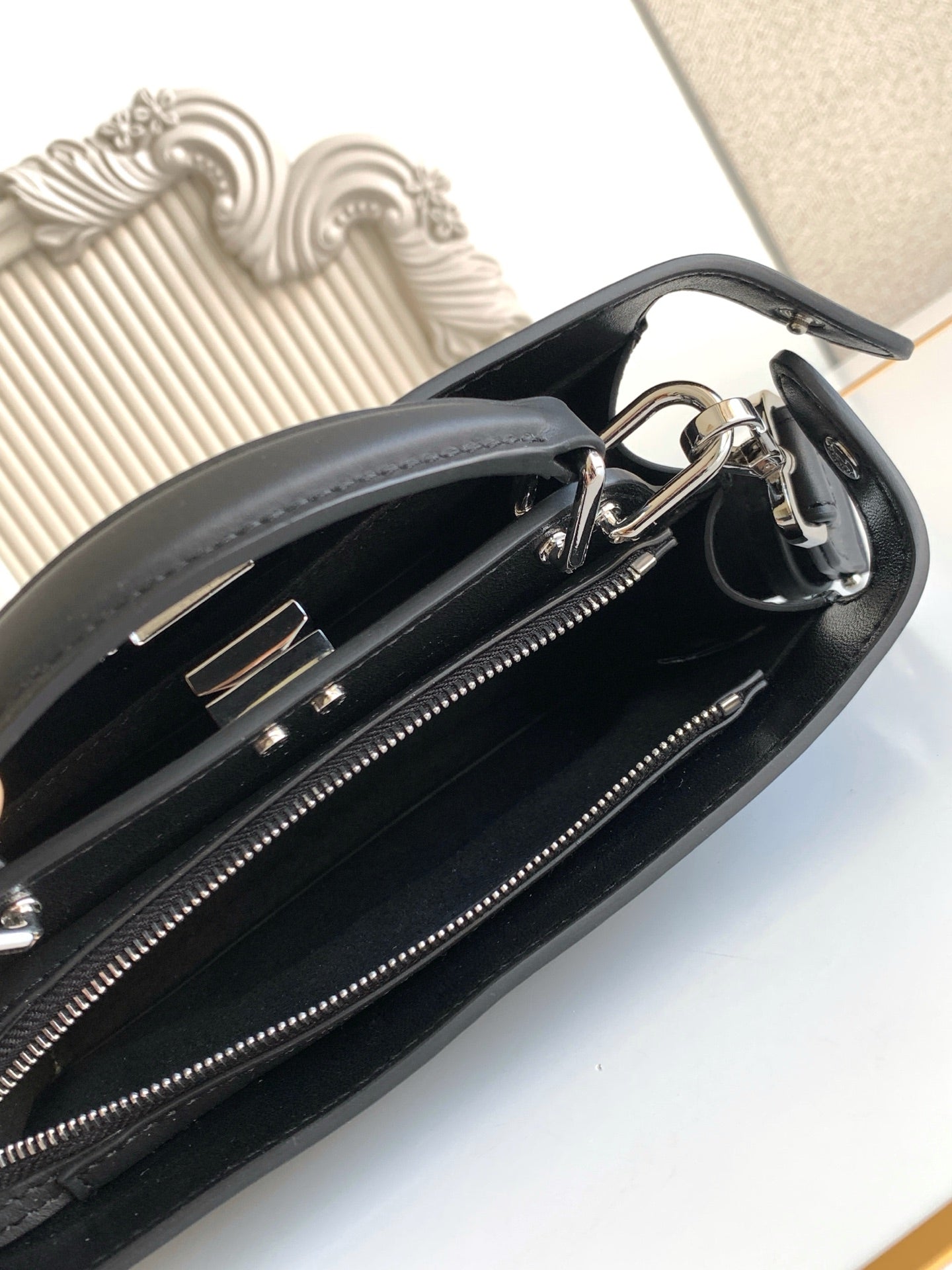 Black Fendi bag interior with zipper track and metal hardware rings