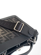 Black Fendi bag strap detail with metal buckle, D-ring, and textured panel