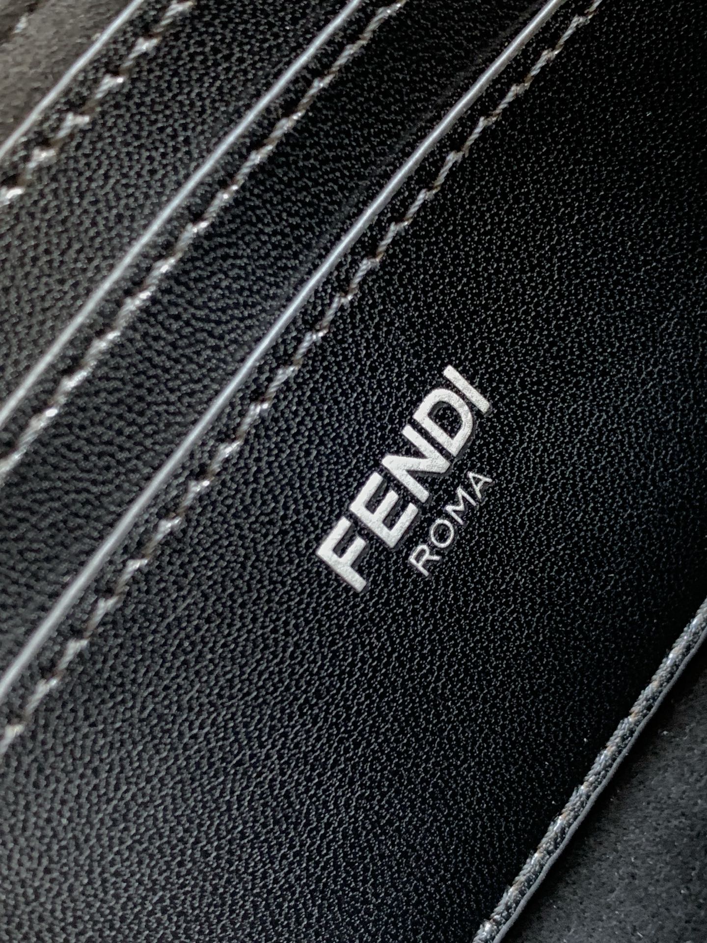 Fendi ROMA logo on black textured bag panel with contrast stitching