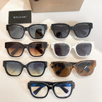 Assorted sunglasses display with black, brown, and white frames and tinted lenses.