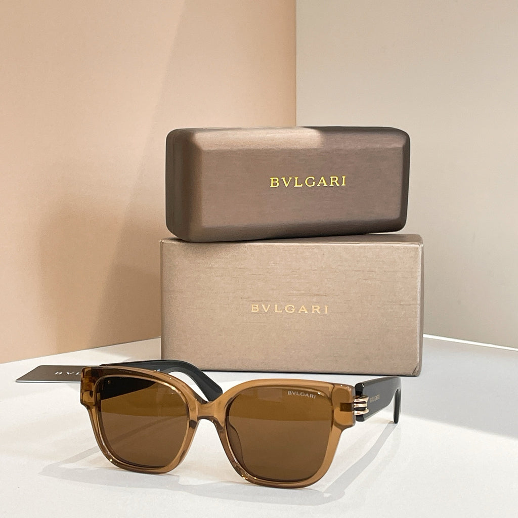 Amber sunglasses with tortoiseshell frames and gold-tone metal hinge detail.