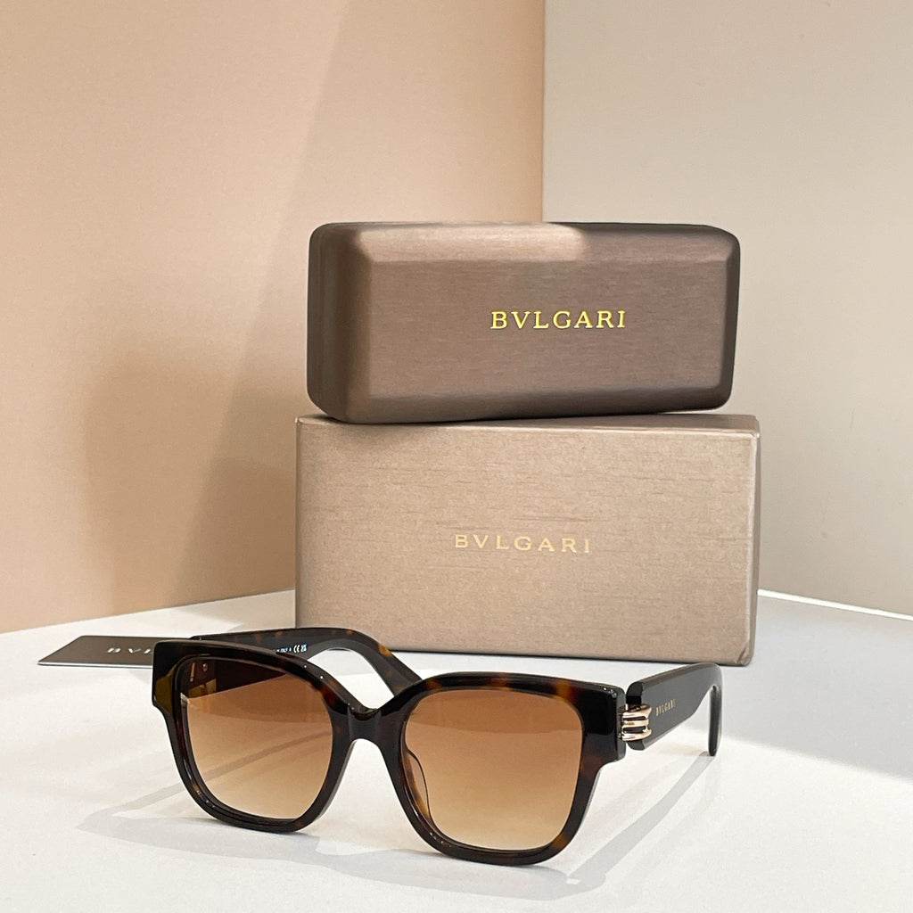 Brown-tinted sunglasses with black frames and metal hinge detail, angular shape.