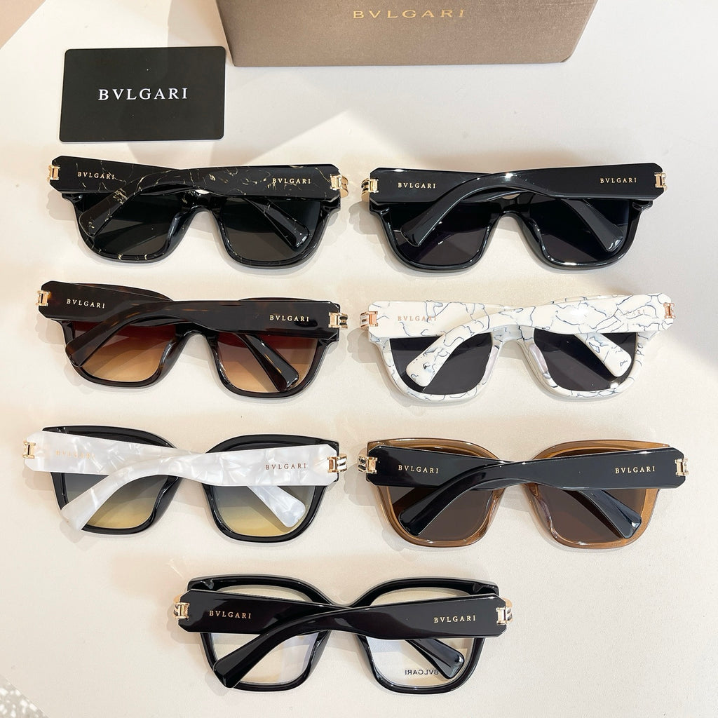Assorted sunglasses display with black, tan, and white frames and dark tinted lenses.