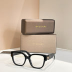 Black square sunglasses with clear-tinted lenses and metal hinge detail, bold frames.